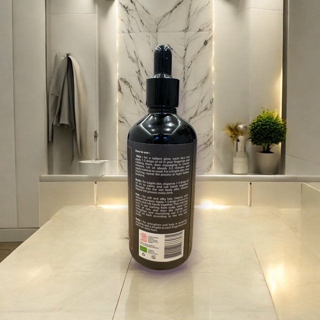 Dos du flacon d’huile d’argan bio avec instructions d’utilisation détaillées.
